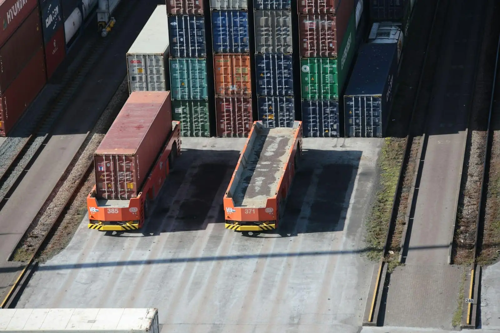 Aerial view of stacked shipping containers and transport trailers in a rail freight yard